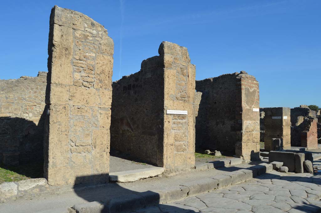 Via della Fortuna, north side, Pompeii. October 2017. 
Looking north-east towards VI.13.5, on left, VI.13.6, in centre, and VI.13.7, near fountain.
Foto Taylor Lauritsen, ERC Grant 681269 DÉCOR.

