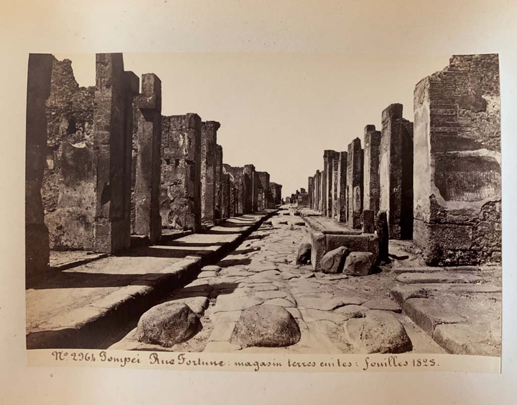 Via della Fortuna, Pompeii. Photograph by M. Amodio, from an album dated April 1878.
Looking west towards fountain between VII.4 and VI.13, and junction with Vicolo dei Vettii, on the right. 
Photo courtesy of Rick Bauer.
