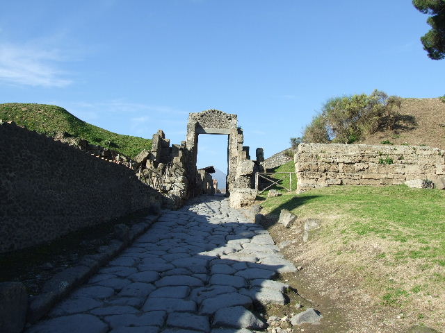Via delle Tombe and the cippus of Titus Suedius Clemens, May 2006. 
Looking south from the crossroads with Via di Nocera. 

