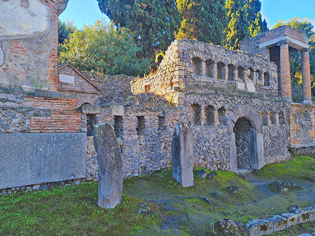 Via delle Tombe, south side, Pompeii. October 2024. 
Looking west along south side of Via delle Tombe from Tomb 1OS, on left, with Tomb 50S, in centre. Photo courtesy of Giuseppe Ciaramella.
