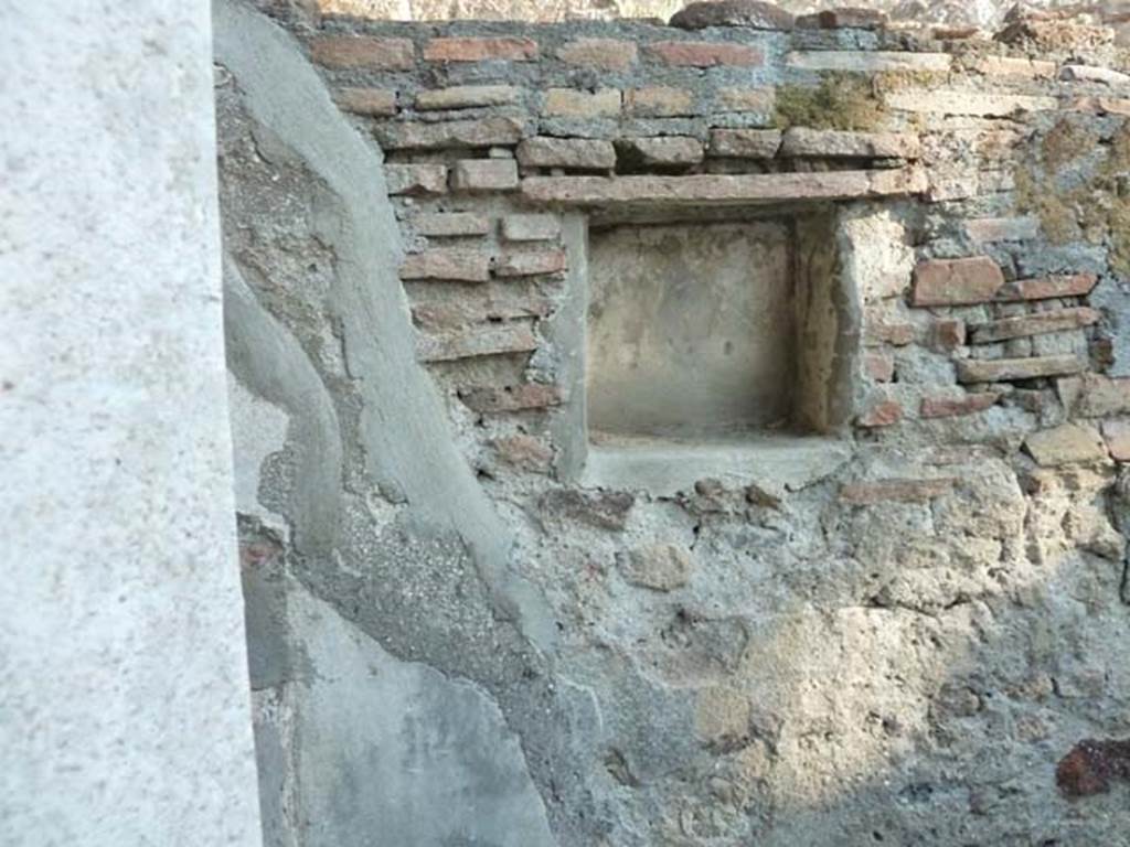 HGW25 Pompeii. September 2015. Lararium in south wall, with remains of a painted Fortuna with rudder and cornucopia. 
No 67, 68 and 69 on the La Vega plan 
From PAH 1,1, p.272-3, 1st May 1773: (addendum p.129 and 159  original at end of photos): (La Vega: 67, 68, 69). 
After having worked for many weeks to lift the earth from around the rustic courtyard of the said dwelling, we have entirely freed two rooms near to the said courtyard. Although, these have very ordinary floors and everything poorly arranged, they are not worth mentioning having some ordinary paintings decorated with panels.
These (rooms) would have been used by the servants of the owners, because of the worktools found used to cultivate the soil, and for cooking, and for the large quantity of ordinary vessels that there were, that is to say water-jugs, pots of many sorts well smoked, and caraffes, many of which were found broken.
The entire things found in the indicated rooms were - (see page 273 for the list of the finds, Bronze, Glass, Terracotta)
In the entrance of the courtyard, there was a small room with the usual; and in a small niche of the same room, there was a painted Fortuna, as one could see by the rudder and the horn of plenty. Above this room, there was a partition with burnt straw, of which. (della quale si son fatti prendere alcuni massi)

