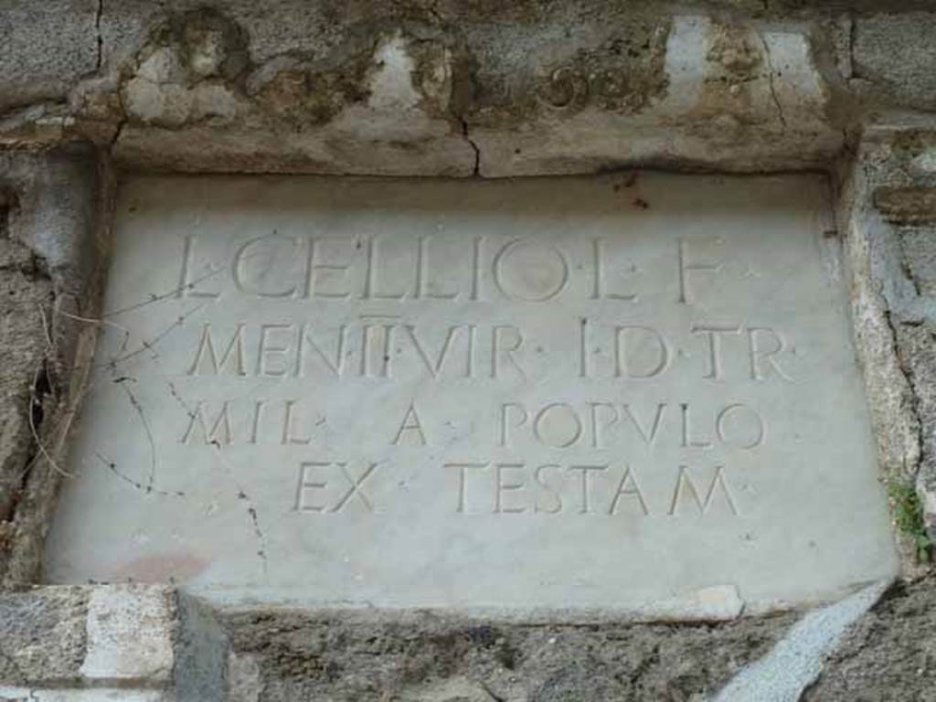 Pompeii Porta Nocera. May 2010. Tomb 4EN, marble plaque with latin inscription:
L(ucio)   CELLIO   L(uci)   F(ilio)
MEN(enia)   II VIR  (duo vir(o))   I(ure)   D(icundo)  TR(ibuno)
MIL(itum)   A   POPVLO
EX  TESTAM(ento).
See DAmbrosio, A. and De Caro, S., 1983. 
Un Impegno per Pompei: Fotopiano e documentazione della Necropoli di Porta Nocera. 
Milano: Touring Club Italiano. (4EN).


