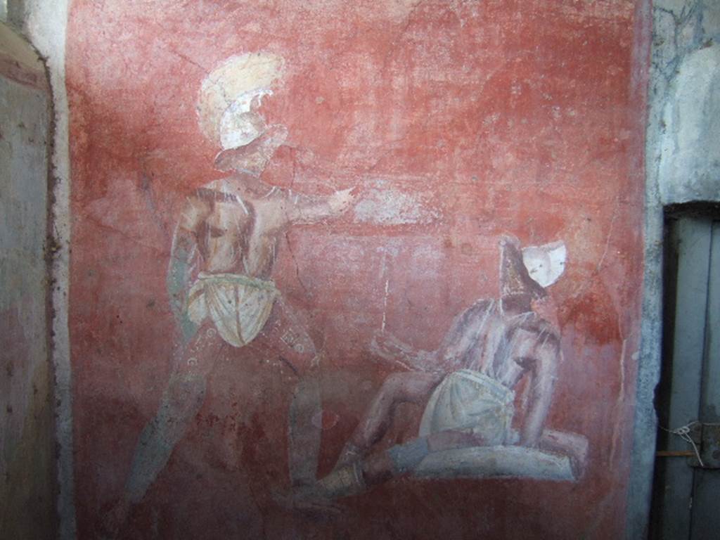 VGJ Pompeii.  May 2006.  Inner side of west wall of tomb with entrance door on right.  Painting of a gladiator fight hosted by or held in honour of the deceased.