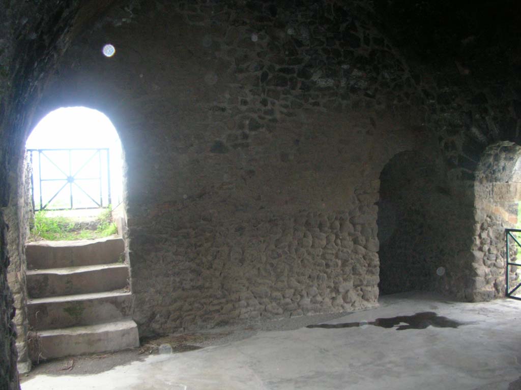 Tower XI, Pompeii. May 2010. South wall of middle floor, with steps and doorway leading up to upper floor, on left.
On right, doorway in west wall leading onto wall/walk. Photo courtesy of Ivo van der Graaff.
