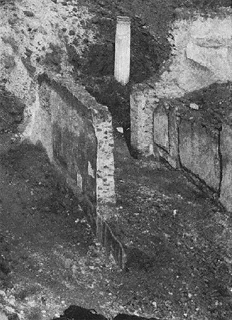 Villa of P. Fannius Synistor at Boscoreale. The excavations during reburial in mid September 1900.
Fauces C leading to the south-east corner of the peristyle E, which has its corner column at the end of the fauces.
The house could be segregated from the work and baths areas.
It was entered through the fauces (room C) which opened in the middle of the portico that acted as a vestibule. 
It was roughly six metres long, 3 wide and had mosaic flooring of various colours, in a geometric design. 
The walls were decorated in a simple and yet rich manner.  
To the right and left, a small portico was marvellously painted consisting of marble fluted columns, which rested on a greenish-coloured podium.
See Barnabei F., 1901. La villa pompeiana di P. Fannio Sinistore. Roma: Accademia dei Lincei. p. 21-22.
