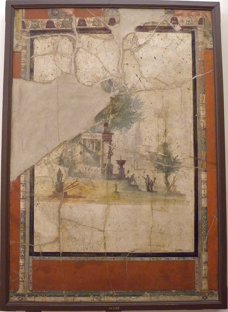Villa Agrippa Postumus. Boscotrecase. Room 16, west wall.
The west wall had at its centre a white ground panel depicting an architectural landscape of Alexandrian style with statues, fountains and travellers in front of a shrine overshadowed by a leafy tree.
Now in Naples Archaeological Museum. Inventory number 147503.
