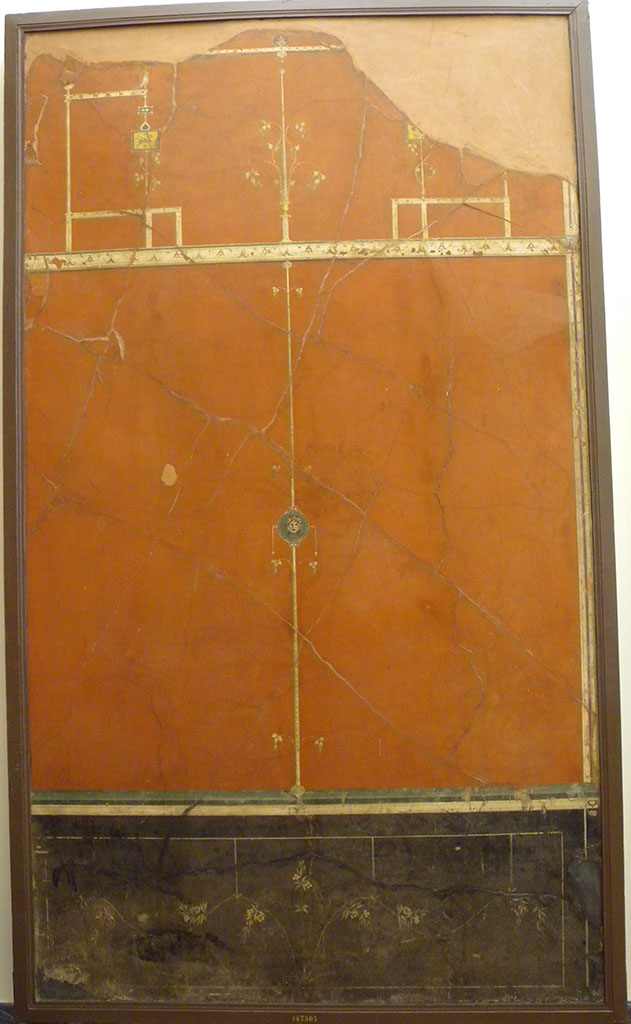 Villa Agrippa Postumus. Boscotrecase.Room 16, east wall.
Now in Naples Archaeological Museum.  Inventory number 147505.
On the right-hand wall the decorative scheme of the left-hand wall was repeated with duplication of decorative details such as the elegant branches of the dado/plinth, suspended from the cornice of the panels by delicate ribbons.
