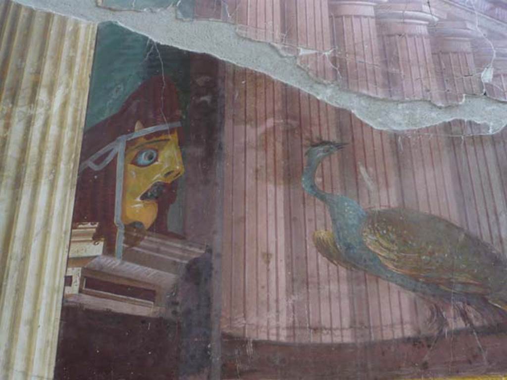 Oplontis, May 2010. Room 15, detail of tragic mask and peacock, from north end of east wall. Photo courtesy of Buzz Ferebee.