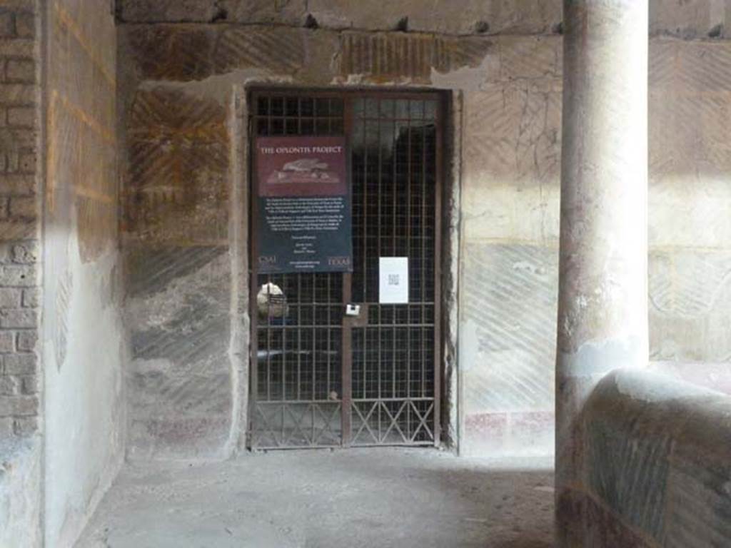 Oplontis Villa of Poppea, September 2015. Doorway to room 35 in north-west corner of peristyle 32.
Notices outlining the work of The Oplontis Project are attached to the grille.
