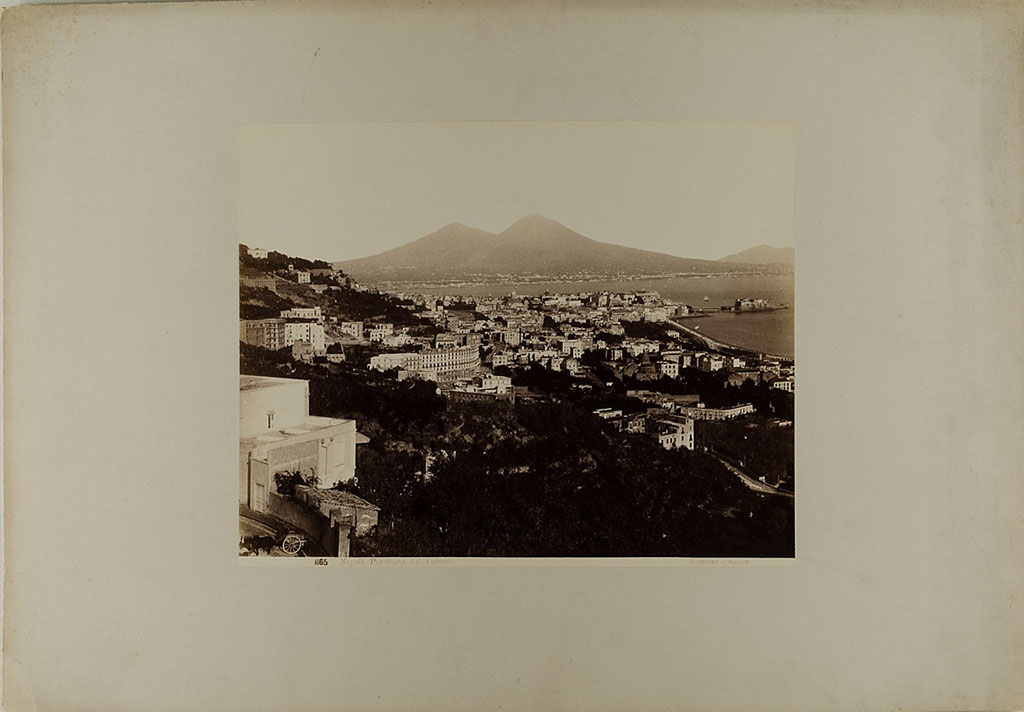 Vesuvius, 1860-1890. View of Naples from the Vomero district, with Vesuvius in the distance.
Photo title at bottom is “No. 1165. Napoli. Panorama dal Vomero Sommer – Napoli”. 
Museum für Kunst und Gewerbe Hamburg, inventory number P1981.370 (Public Domain).
See https://sammlungonline.mkg-hamburg.de/de/object/No.-1165.-Napoli.-Panorama-dal-Vomero/P1981.370/mkg-e00135889
