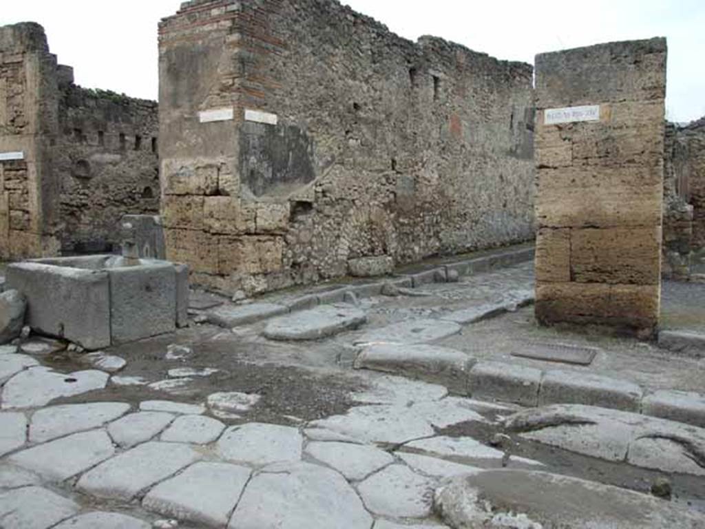 Fountain outside VI.13.7. Via della Fortuna, north side, May 2010. Looking west towards junction with Vicolo dei Vettii between VI.13 and VI.14.