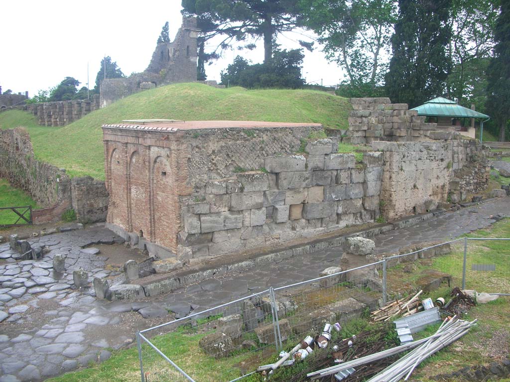 Vesuvian Gate, Pompeii. May 2010. 
Looking north-west from south end, with Castellum Aquae leaning against west wall, in centre, with narrow sidewalk, and Tower X, in background. 
On the left are lava cippi, as described by Sogliano, and apparently acting as kerbstones. Photo courtesy of Ivo van der Graaff.

