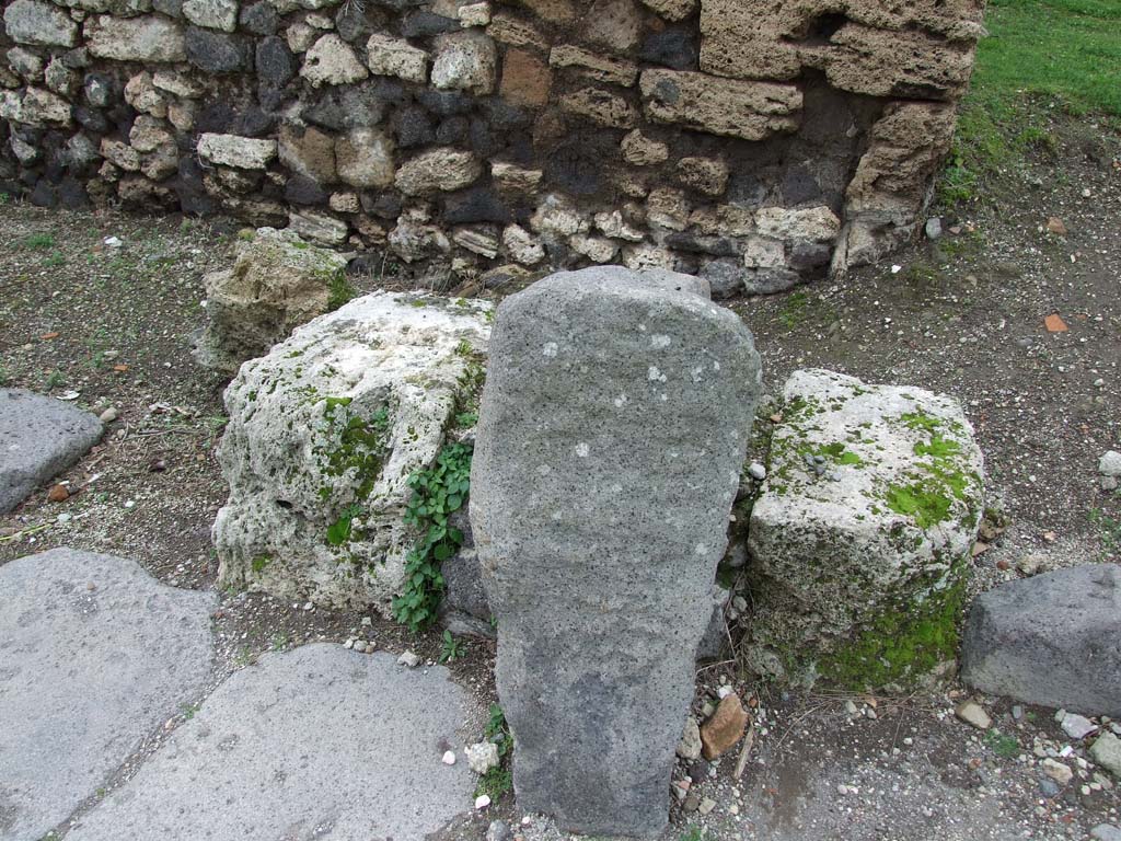 Vesuvian Gate Pompeii. May 2006. West side, north-west corner of area C, block of limestone.
According to Sogliano -
“At either end of the vestibule [C] are two strong pillars in blocks of limestone and masonry. 
The West pillar, somewhat smaller than the other, is 0.90 m from the wall, while the another now missing was undoubtedly to the East wall. 
Between the Western pillar and the wall there was a narrow side passage, as at Porta Marina and Herculaneum Gate. 
An arch connected the Western pillar with the wall; a second, much larger, joined this same pillar with the Eastern one, and both making a large vault covering the Vestibulum C. 
The narrow passage B, with the gate doors, was similarly covered. 
Whether passage A was covered or uncovered is not known.
See Notizie degli Scavi di Antichità, 1906, p. 97-100.
