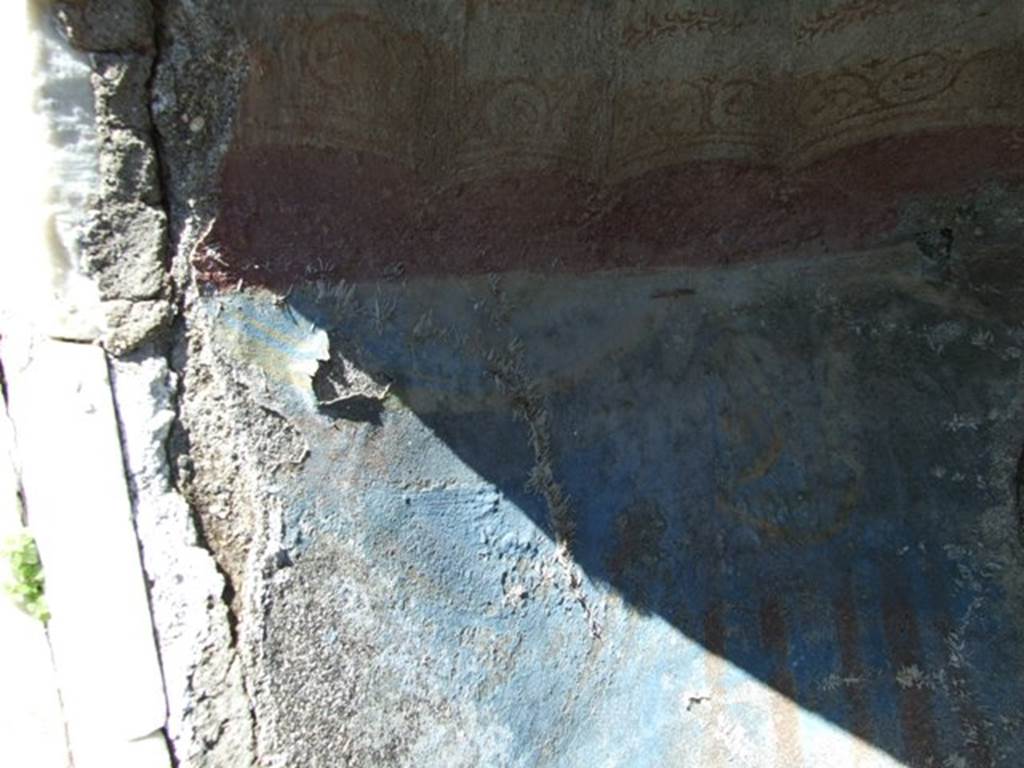 I.2.17 Pompeii.  March 2009. North end of Niche on East wall. Detail of the remains of painted blue drapery.
