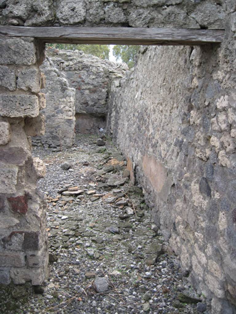 I.3.8b Pompeii. September 2010. Looking south from doorway of west portico towards oecus and repository in south-west corner of property. Photo courtesy of Drew Baker.
