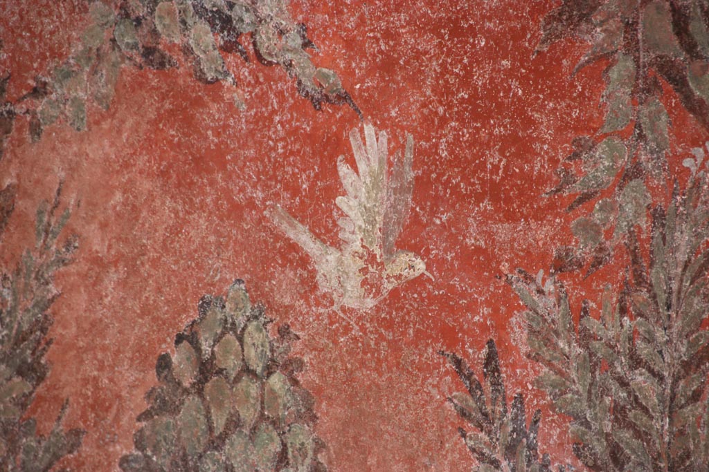 I.6.15 Pompeii. October 2023. 
Room 9, detail of painted bird on south side of window in east wall of small garden. Photo courtesy of Klaus Heese.
