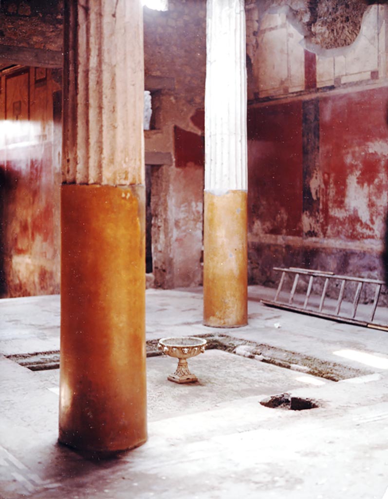 I.6.15 Pompeii, 1980 (pre-earthquake). 
Room 4, looking south-west across impluvium in tetrastyle atrium, towards labrum fountain with animal masks, later stolen. Today there is only a hole left in the impluvium floor.
Photo courtesy of Espen B. Andersson, who has written a scientific article especially on this fountain.  
See E. B. Andersson, Metamorphoses in Water, in Latomus, 50 (3), 1991, pp.544-562. “
(The article can be read on Academia or ResearchGate.) 
