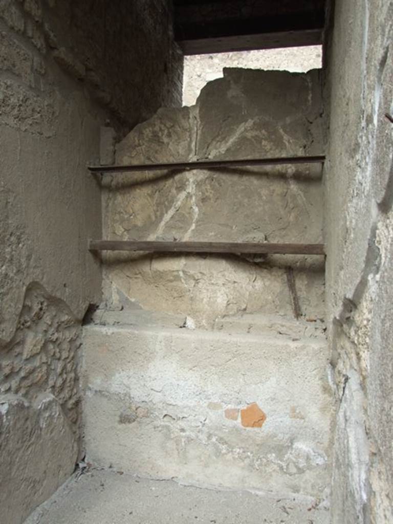 I.9.1 Pompeii. March 2009. Rear of plaster cast of entrance door in fauces.
According to PPM, the floor was of lavapesto which had a carpet design of white tesserae and coloured marble tiles scattered within a row of white tesserae.
