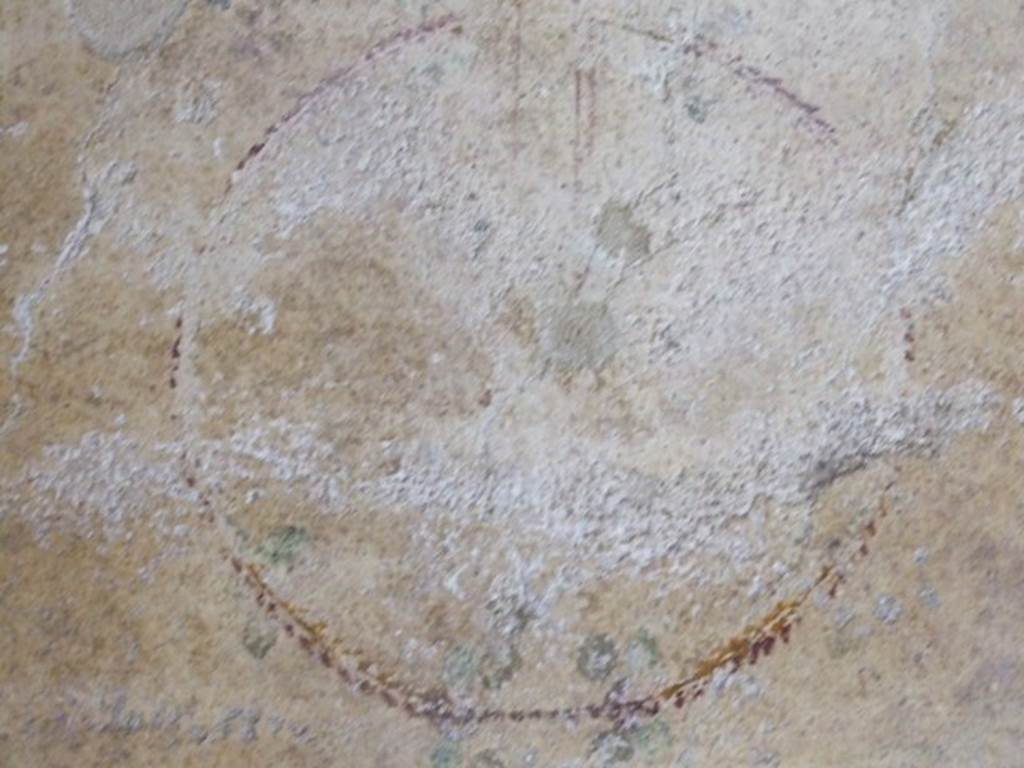 I.9.3 Pompeii. March 2009. Room 3, remains of painted garland showing a crown or medallion from the north end of the middle zone of east wall, on a white background.