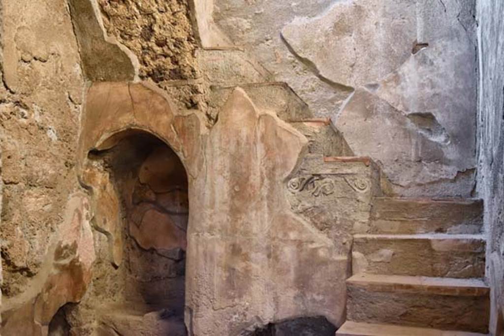 I.10.4 Pompeii. April 2018. Looking towards the recess with small masonry altar with two cavities in the top, lower left. Photo courtesy of Ian Lycett-King. Use is subject to Creative Commons Attribution-NonCommercial License v.4 International.
