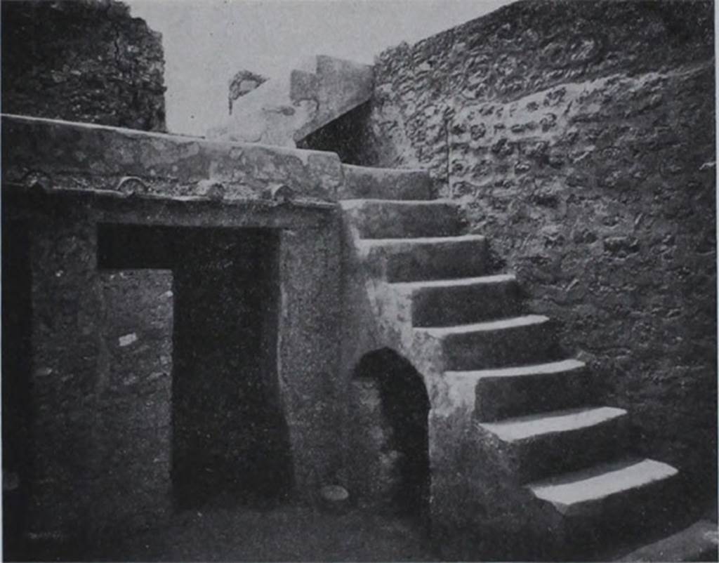 I.10.8 Pompeii. Room 5, south-west corner of the yard, with stairs to upper gallery and cupboard under, and doorway to small room.
These masonry steps against the west wall, were covered with a coating of cocciopesto, and consisted of 9 steps leading to a gallery on which opened a room on the upper floor to the east. From this then, by another four steps, one arrived at the western rooms of the upper floor.
Al lato occidentale una scalinata di fabbrica, rivestita di intonaco di cocciopesto, di nove gradini che porta ad un ballatoio, sul quale si apre un ambiente del piano superiore ad est. Da questo poi per altri quattro scalini, si accede al quartierino ovest del piano superiore.
See Notizie degli Scavi di Antichità, 1934, p. 311, fig. 24.