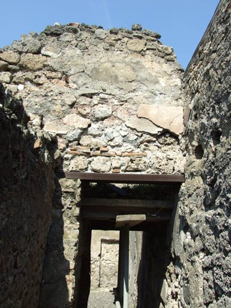I.10.8 Pompeii. March 2009. Looking north from latrine along narrow area in south-east corner of room 5, the yard.