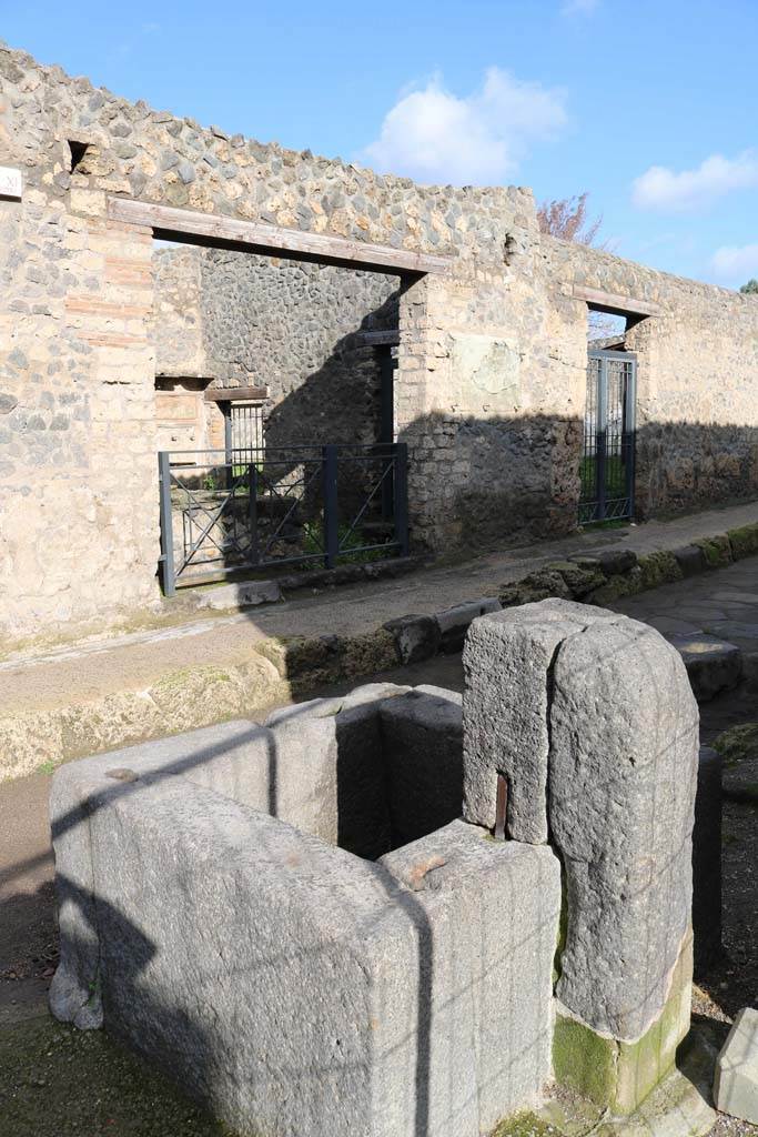 I.11.11 and I.11.10, Pompeii. December 2018.
Looking towards entrance doorways on north side of Via di Castricio, from fountain outside of I.16.4.
Photo courtesy of Aude Durand.