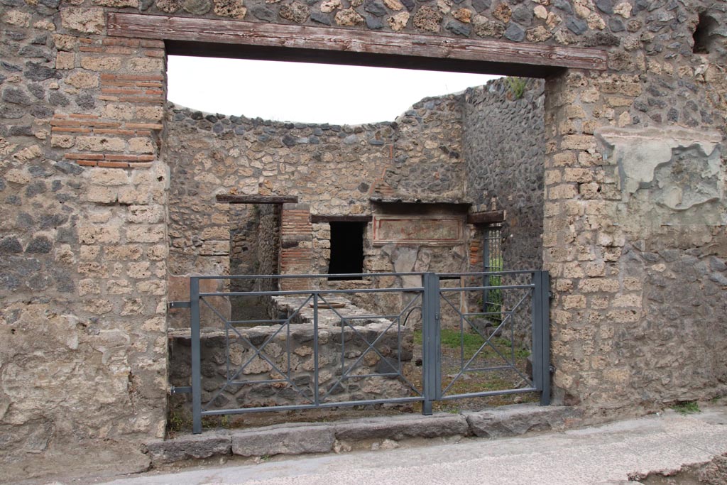 I.11.11 Pompeii. May 2024. Looking north-east to entrance doorway, with bar-counter. Photo courtesy of Klaus Heese.