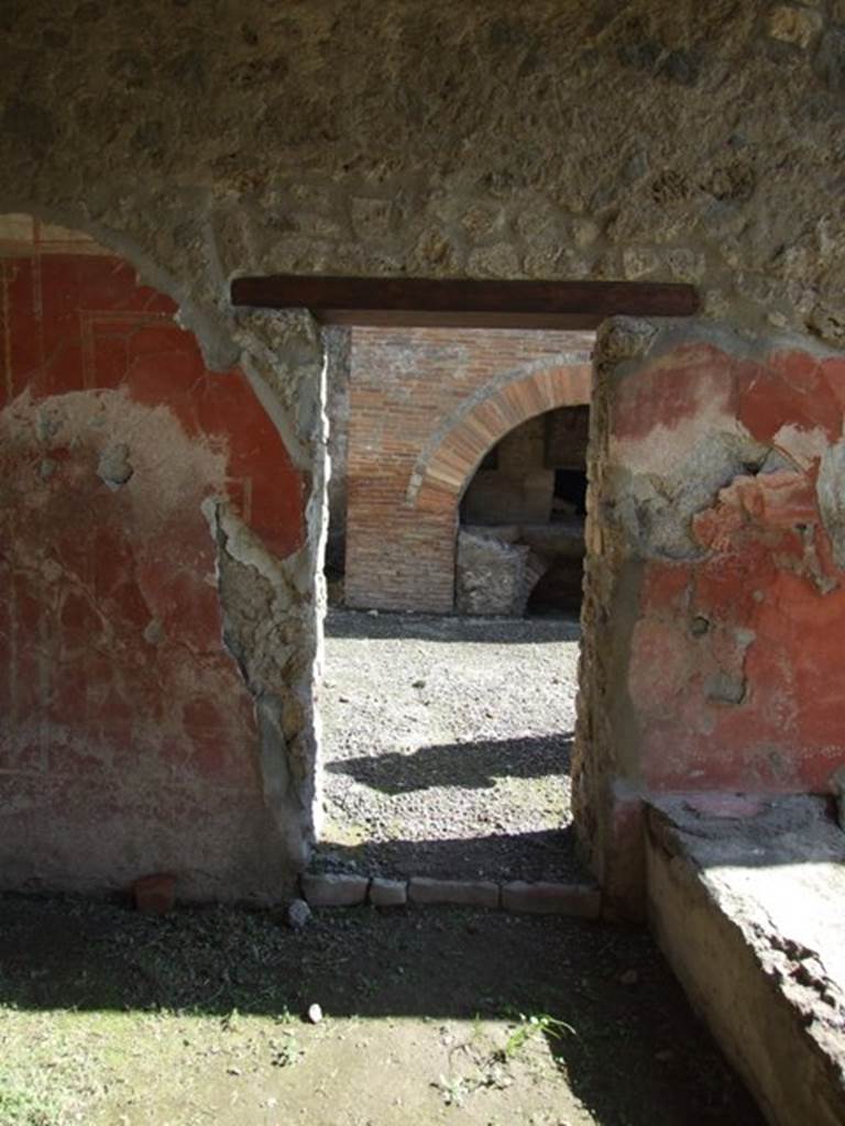 I.12.2 and I.12.1 Pompeii. March 2009. Doorway to room 11 in east wall of portico.