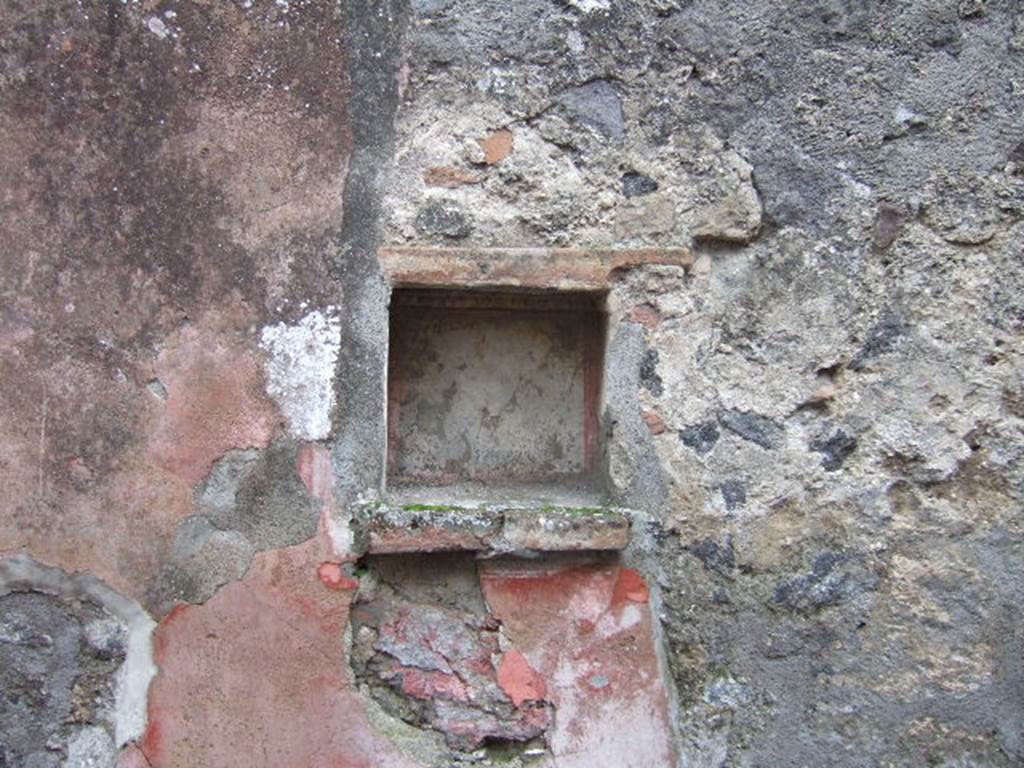 II.2.3 Pompeii. December 2005.Caupona/Thermopolium of Athictus.
According to Boyce, in the east wall was a square niche with heavy projecting ledge. Its inside walls were white, bordered in red and around the top ran a stucco cornice. A similar cornice ran around three sides of the niche on the wall outside, to judge from the one side where the plaster was preserved. On the edge of the projecting shelf was a graffito. See Della Corte, M., 1965.  Case ed Abitanti di Pompei. Napoli: Fausto Fiorentino. (p.379, CIL IV 8489). See Boyce G. K., 1937. Corpus of the Lararia of Pompeii. Rome: MAAR 14. (P.30, no.63, Pl.4, 3, the location given as II.v.3)

According to Epigraphik-Datenbank Clauss/Slaby (See www.manfredclauss.de) this read as

Oliva condita
XVII K(alendas) Novembres      [CIL IV 8489]
