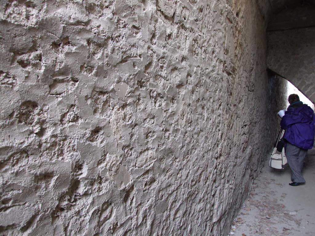 II.4.6 Pompeii. December 2006. Corridor to rear of nymphaeum, with blocked door in outside wall, looking north.