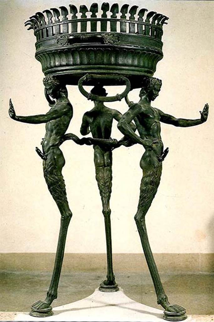 II.4.6 Pompeii. Found in the sacrarium 15th June 1755.
Bronze brazier tripod supported by three ithyphallic satyrs as legs.  
Now in Naples Archaeological Museum. Inventory number 27874.
