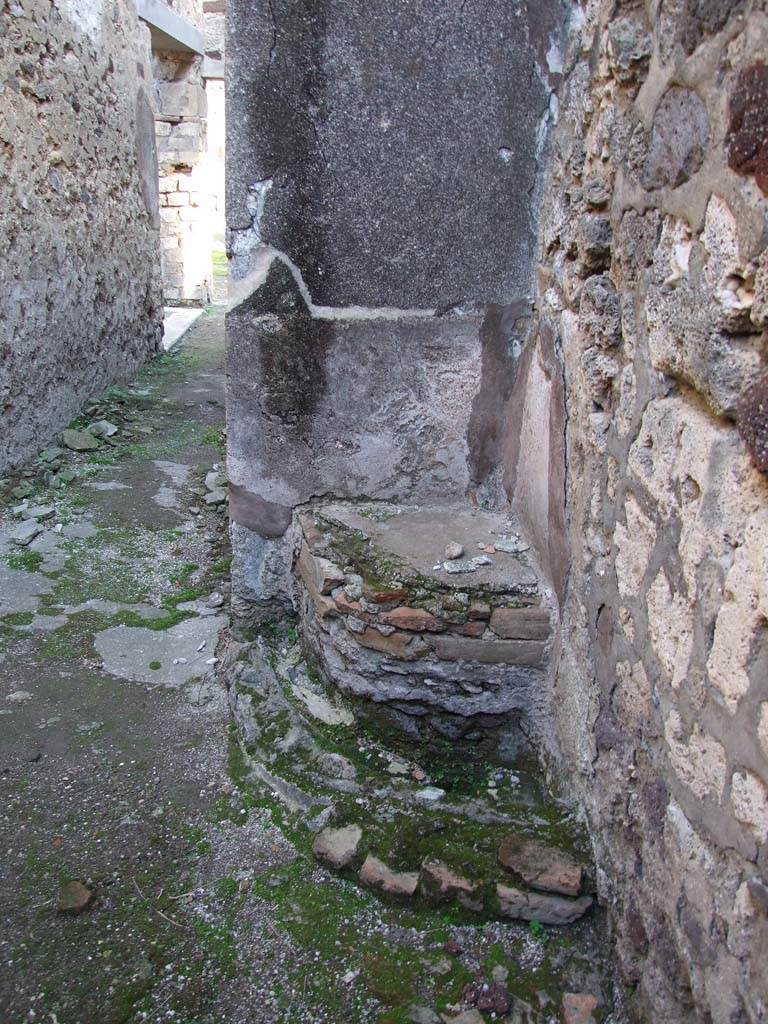 V.1.7 Pompeii. December 2007. Room 20, corridor, looking east. Pedestal on south wall.