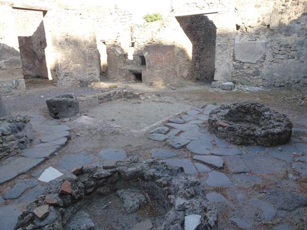 V.3.8 Pompeii. June 2012. Looking south-east across bakery in atrium towards the oven.
Photo courtesy of Michael Binns.