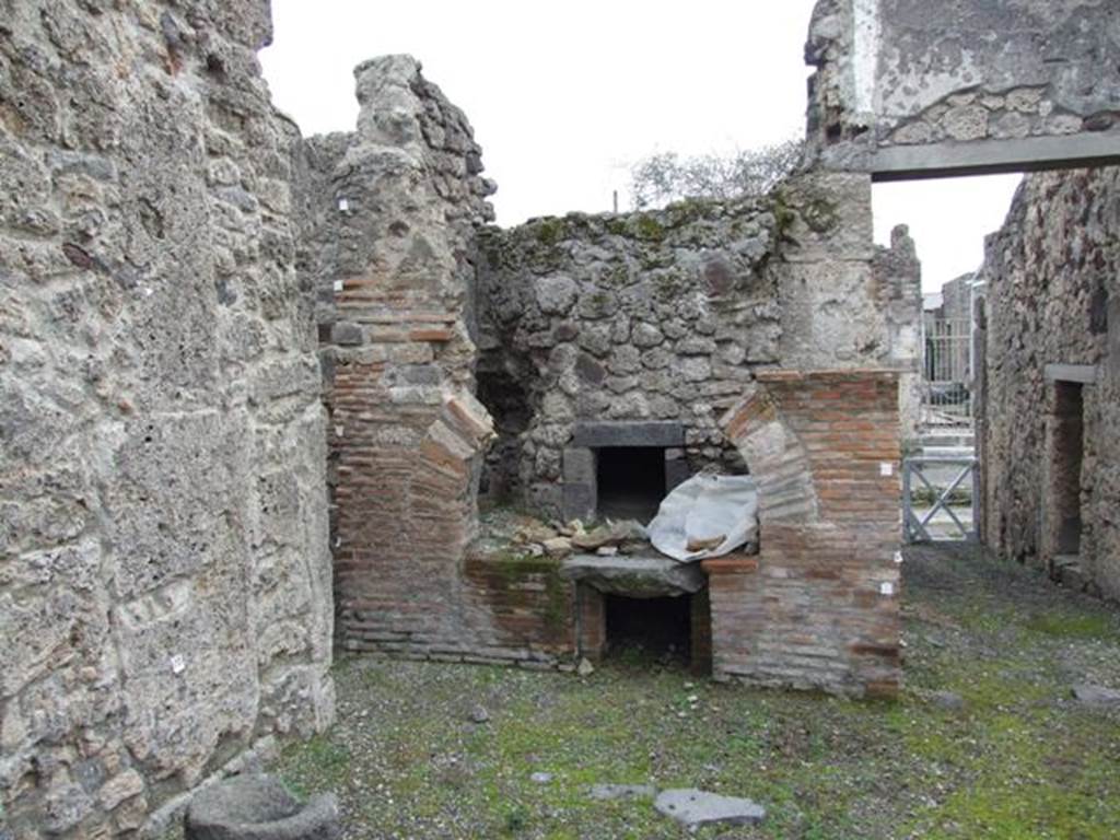 V.3.8 Pompeii. December 2007. Looking south at oven on east side of entrance doorway.