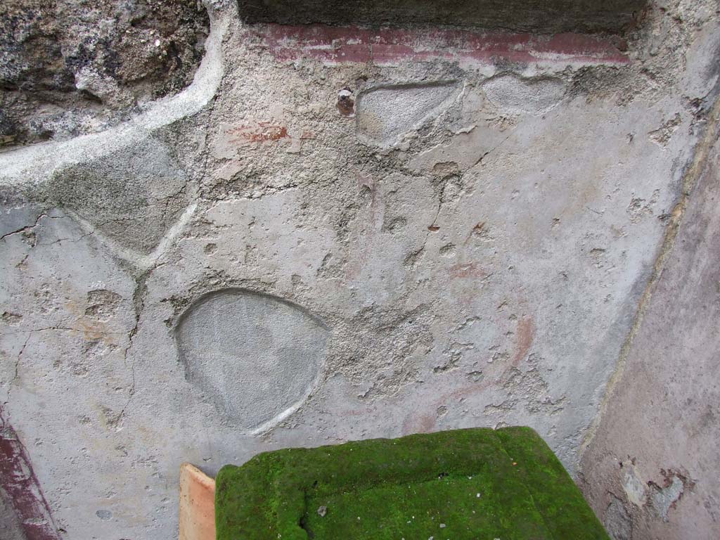 VI.7.23 Pompeii. December 2006. Kitchen.
Wall painting of serpent (Agathodemone) on lararium just visible on north wall of kitchen.
According to Boyce, below the niche a yellow serpent with red crest and beard coiled towards a golden cylindrical altar adorned with a gorgoneion.
On top of the altar was a fire. Before the painted altar, an altar of tufa stands on the floor.
See Boyce G. K., 1937. Corpus of the Lararia of Pompeii. Rome: MAAR 14. (p.48, no.167, and Pl.11,1) 
