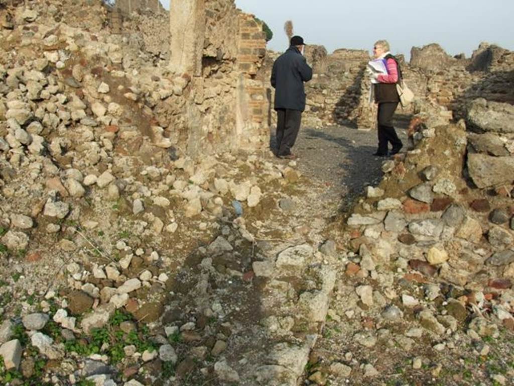 VI.9.1 Pompeii. December 2007. Looking east across remains of rooms on east side of VI.9.1 from area of walkway room 4, towards corridor/tablinum into VI.9.14.
