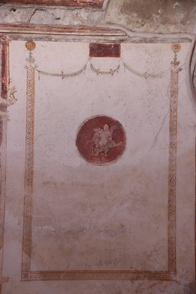 VI.15.1 Pompeii. October 2024. 
Painted panel at north end of west wall of oecus. Photo courtesy of Klaus Heese. 
