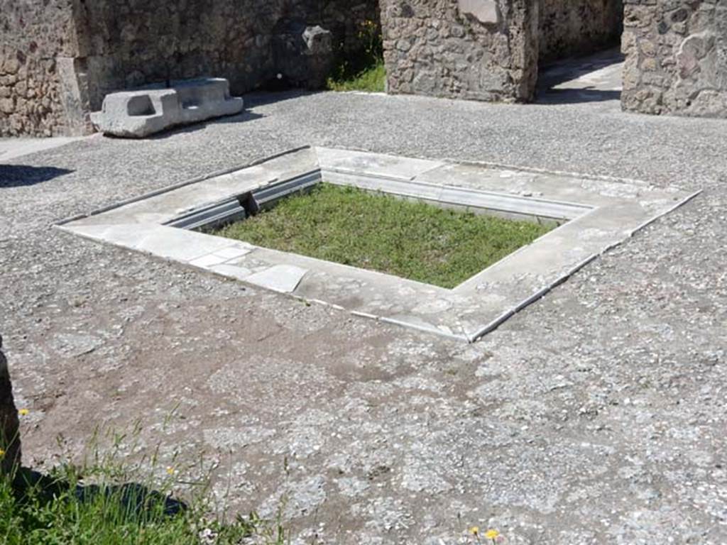 VII.7.5 Pompeii, May 2018.
Looking south-west across atrium towards large piece of travertine for the strong-box, and doorways to rooms (c) and (d) on west side of atrium.
Photo courtesy of Buzz Ferebee.