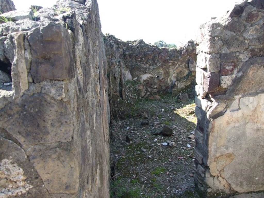 VII.15.2 Pompeii. March 2009. Tepidarium with doorway into caldarium.
The caldarium had a hypocaust system, complete with suspensurae beneath its floor. Regulae mammatae lined its south, west, and north walls. The praefurnium was stoked from the kitchen, which was on the west side.  The wall decoration of the caldarium was Second style, but no further details were recorded.  The floor was paved with cocciopesto.
See Franklin, J.L., 1990. Pompeii, the Casa del Marinaio and its history. Rome: L�Erma di Bretschneider

