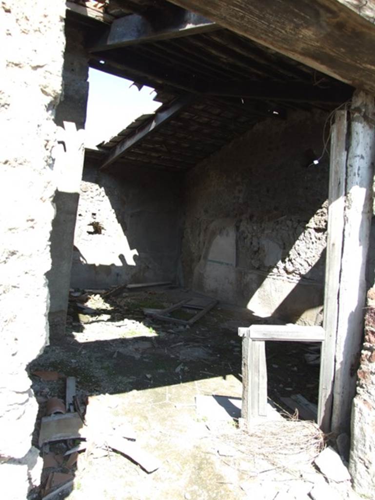 VII.15.2 Pompeii. March 2009. Apodyterium, or lounging room. The large lounging room was entered through the second doorway on the left of the corridor. It was windowless and appears to have been given its wide doorway especially to receive light from the court. Its pavement was lavapesto decorated with white marble tesserae tracing an interlaced double hexagonal pattern. On the walls were large paintings of Polyphemus and Galatea (west wall), The Slaughter of the Niobids (north wall), The Punishment of Dirce (east wall), and Perseus and Andromeda (south wall). All were damaged, and their original height is unknown, but all measured 1.62 m. in width. See Franklyn, J.L., 1990. Pompeii, the Casa del Marinaio and its history. Rome: L’Erma di Bretschneider.