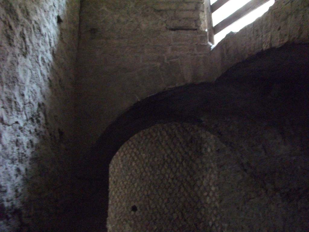 VII.16.a Pompeii. May 2010. Arch in corridor D, looking through to room 15. Above the arch are the stairs to the upper floor.