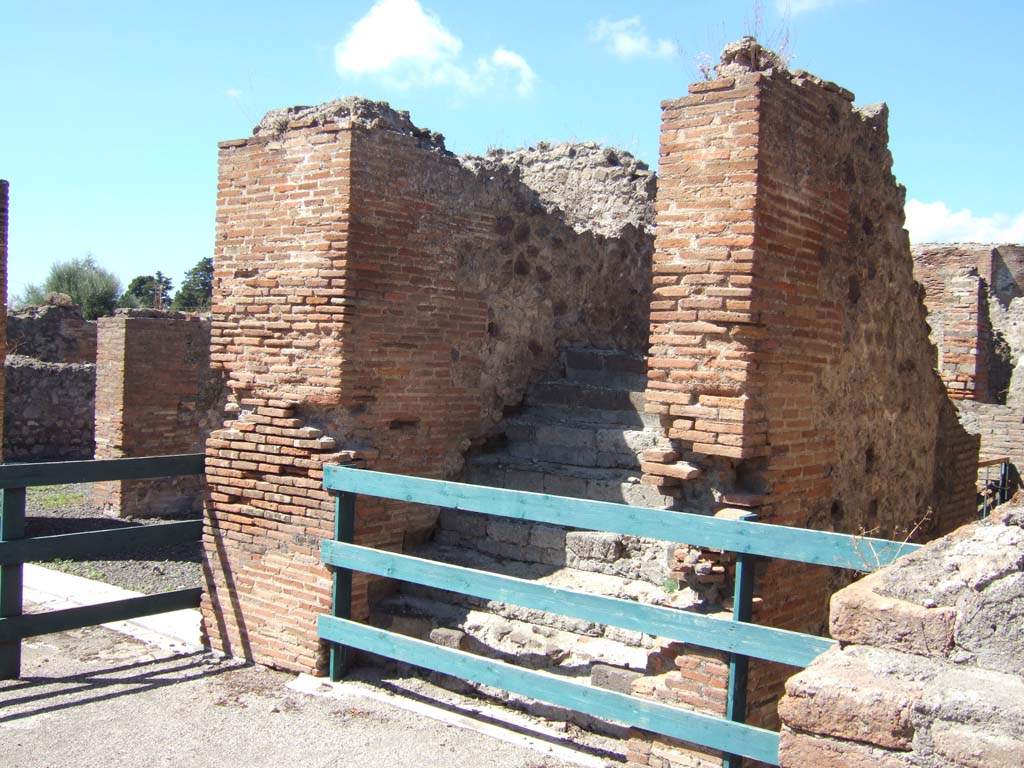 VIII.2.16 Pompeii. September 2005. Steps to upper floor, in north-east corner of portico, with corridor from VIII.2.14, on right.