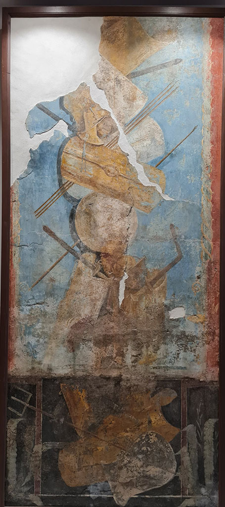 VIII.7.16 Pompeii. Wall of the exedra.
Painting of trophy of arms above a painting of the arms used by gladiators.
This is the larger fresco, 252.4cm high by 112 cm wide.
Now in Naples Archaeological Museum. Inventory number 9702.
See Sampaolo V., Frammenti di affreschi con armi gladiatorie in Restituzione: Tesori d’arte restaurati 2013, p. 103.
Photo courtesy of Giuseppe Ciaramella.