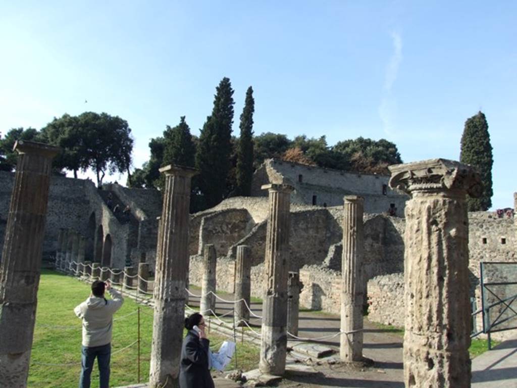 VIII.7.16 Pompeii. December 2007. North east corner outside the doorkeeper’s room. Looking across the north side to staircase to the Triangular Forum and the walls of the upper storey of the Large Theatre.