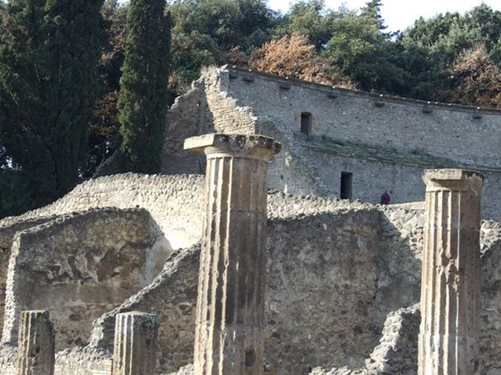 VIII.7.16 Pompeii. December 2007. Looking over the Doric columns of the colonnade to the walls of the upper storey of the Large Theatre.
