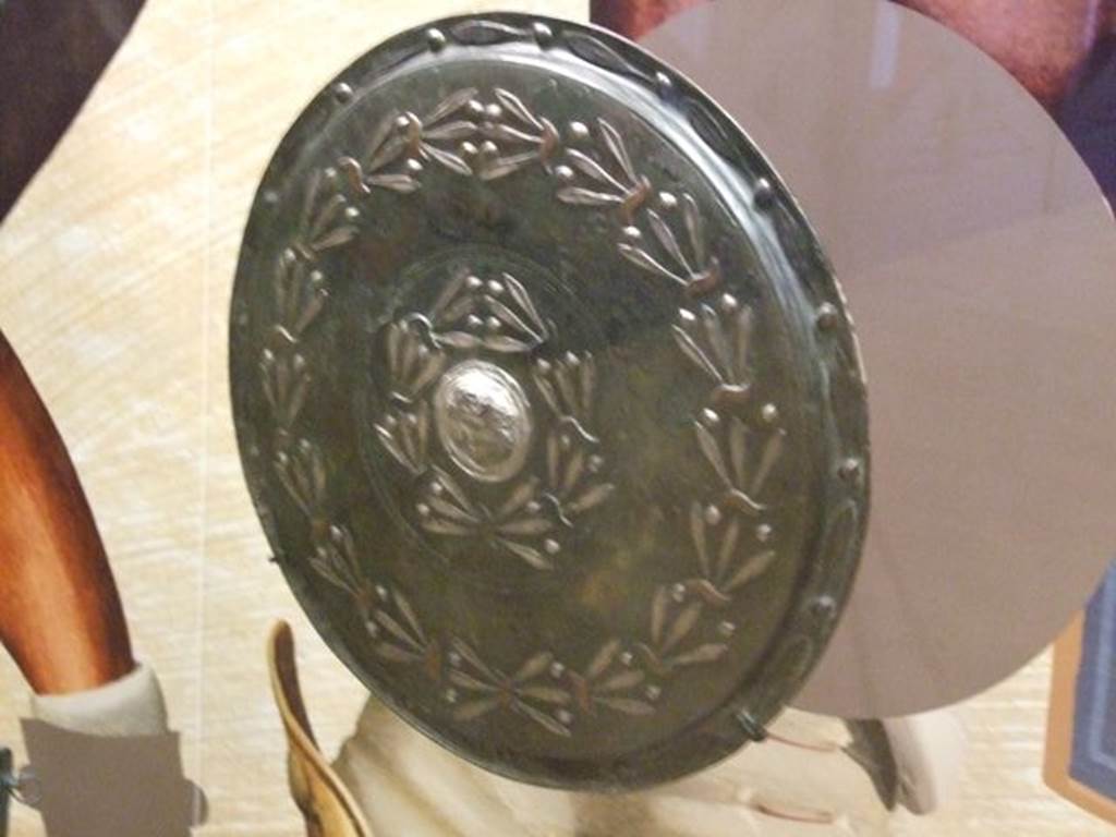 VIII.7.16 Pompeii. September 2009. Bronze and silver shield. Now in Naples Archaeological Museum. Inventory number 5669.
Photographed at “A Day in Pompeii” exhibition at Melbourne Museum.