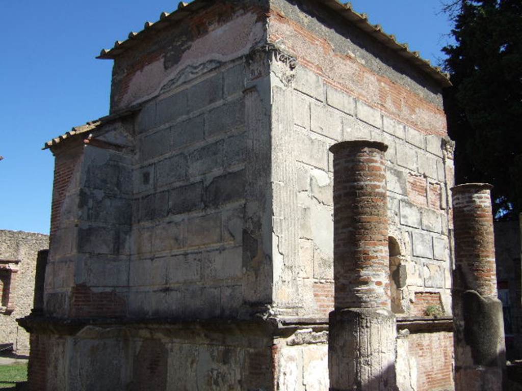 VIII.7.28 Pompeii. December 2007. Looking towards north, on left, and west, on right, rear walls of temple cella looking south-east.