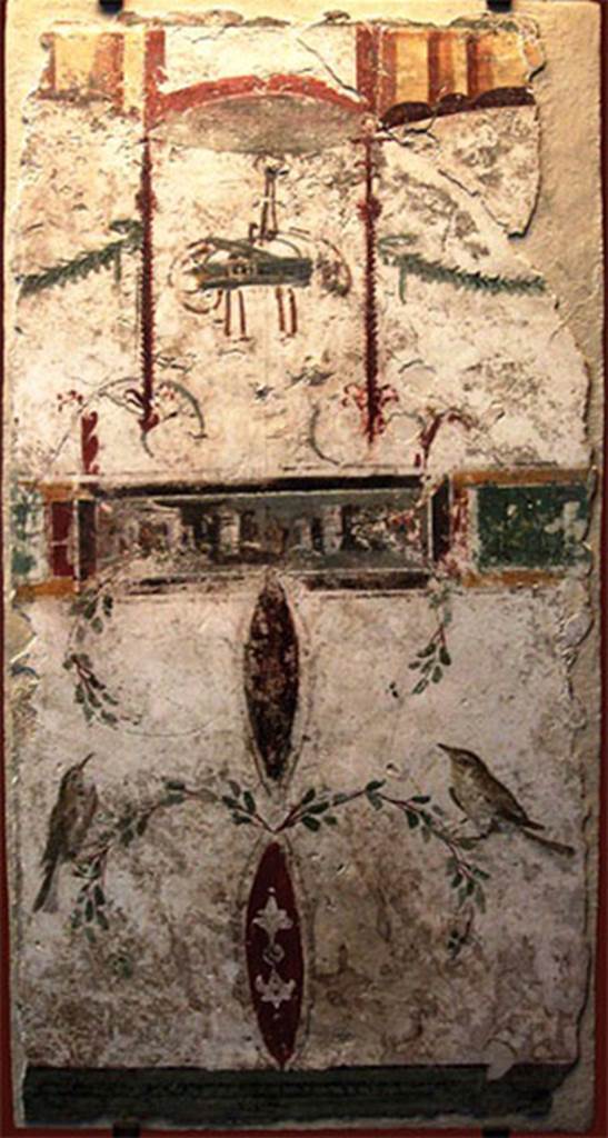 VIII.7.28 Pompeii. Part of the portico? Painting with basket, two birds and a landscape.
In the upper part a basket is suspended between two garlands, possible allusion to one of the rites of the cult to Bacchus, in which sacred objects were transported in baskets. 
At the bottom are two birds delicately landed in branches. 
The frame with a landscape placed in the centre was added later, perhaps to fill the space then empty. 
Now in the Museu Nacional/UFRJ Brazil.
Following the disastrous fire at the Museum on 3rd September 2018 this may have been destroyed.

Este afresco aproxima-se estilisticamente das pinturas de Herculanum e de Stabies. Apresenta na parte superior um cesto suspenso entre duas guirlandas, possível alusão a um dos ritos do culto a Baco, em que objetos sagrados eram transportados em cestos. Na parte inferior estão dois pássaros delicadamente pousados em ramagens. O quadro com uma paisagem colocado no centro foi acrescentado posteriormente, talvez para preencher o espaço então vazio. 
See http://www.museunacional.ufrj.br/dir/exposicoes/arqueologia/culturas-mediterraneo/arqcmed004.html
