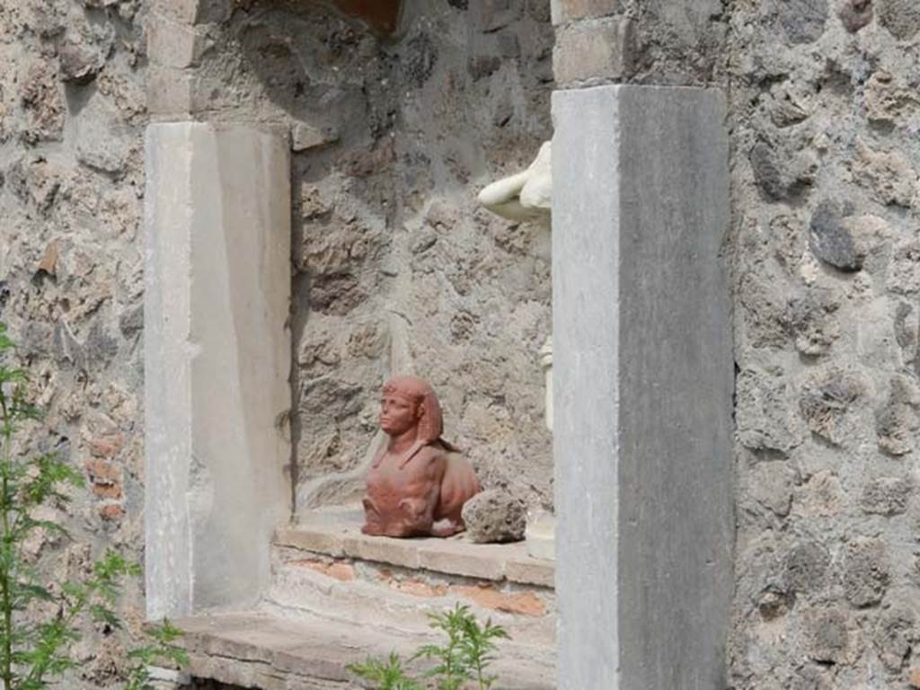 VIII.7.28 Pompeii. May 2017. Niche with reproduction pottery sphinx in north-west corner of the sacred room or Hall of initiation. 
Now in Naples Archaeological Museum. Inventory number 22572.
Also in the niche is a reproduction marble statue of Venus Anadyomene (Venus drying her hair after a bath). 
Found against the west wall of the portico in the south west corner.
Now in Naples Archaeological Museum. Inventory number 6298.
Photo courtesy of Buzz Ferebee.
